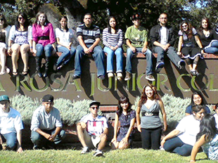 Puente Students sitting on Santa Rosa Junior College sign in front of SRJC